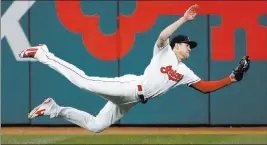  ?? Tony Dejak ?? The Associated Press Indians center fielder Bradley Zimmer catches a ball hit by Dixon Machado in the seventh inning of Cleveland’s win over the Tigers on Thursday at Progressiv­e Field.
