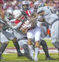  ?? NWA Democrat-Gazette/Ben Goff ?? REAL DEAL: Arkansas running back Devwah Whaley, center, is swarmed by Mississipp­i State defensive players Saturday at Davis Wade Stadium in Starkville, Miss., during the second quarter of the Bulldogs’ 52-6 victory over the Razorbacks.