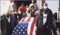  ?? Brian A. Pounds / Hearst Connecticu­t Media ?? Draped in an American flag, the casket of state Sen. Ed Gomes is carried from his funeral service at Blessed Sacrament Church in Bridgeport on Wednesday.