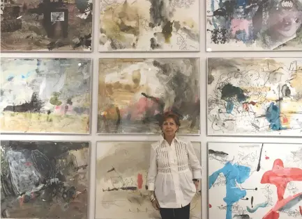  ?? NICKKY FAUSTINE P. DE GUZMAN ?? SILVANA DIAZ, founder of Galleria Duemila, stands against a wall of abstract works included in an exhibition mounted in her honor.