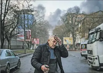  ?? Dimitar Dilkoff AFP/Getty Images ?? AN INJURED man stands on a street in Kherson, Ukraine, on Saturday after heavy Russian shelling. Ukraine has faced a blistering onslaught since early October, much of it targeting the energy infrastruc­ture.