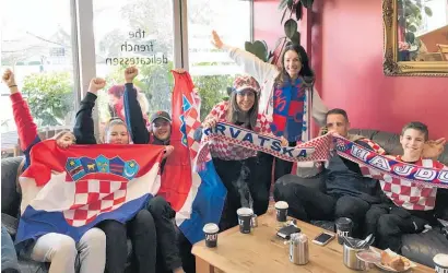  ?? Photo (below) / Greg Bowker ?? Keti Grgicevich (standing) with Natasa Vujnovich (left) and families celebrate Croatia’s win in the World Cup semifinal yesterday. Below: An England fan drowns her sorrows after their 2-1 loss.