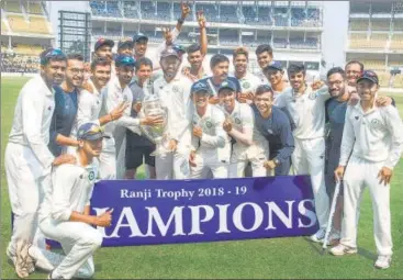  ?? PTI ?? Vidarbha players pose with the Ranji Trophy after defeating Saurashtra in Nagpur last week. This was their second successive title.