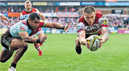  ??  ?? Dive master: Jason Woodward scores a try for Gloucester in their bonus-point victory against Harlequins at Kingsholm