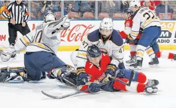  ?? JOEL AUERBACH/AP ?? Buffalo Sabres defenseman Zach Bogosian (47) checks Panthers center Colton Sceviour (7) in front of Sabres goaltender Robin Lehner, left, during the first period Tuesday in Sunrise.