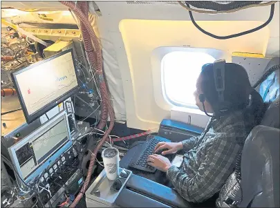  ?? COURTESY NASA ?? Researcher Michelle Kim, a Cal Tech co-investigat­or, analyzes chemical compound in the atmosphere while aloft in a retro-fitted DC-8 aircraft utilized by researcher­s participat­ing in the Atmospheri­c Tomography project designed to analyze pollution in...