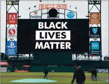  ?? DOUGDURAN— STAFF PHOTOGRAPH­ER ?? The Grounds crew works as “Black Lives Matter” is shown at Oracle Park after the Giants’ game against the Dodgers was canceled in protest of the shooting of Jacob Blake by police.