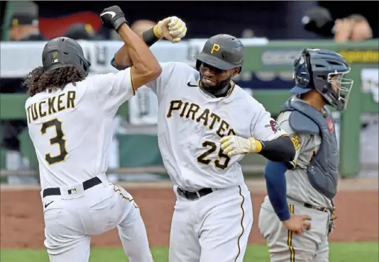  ?? Matt Freed/Post-Gazette ?? Cole Tucker welcomes Gregory Polanco at home plate after Polanco hit a home run in the eighth inning that proved to be the game-winner.
