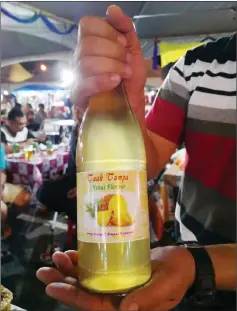  ??  ?? A bottle of pineapple- avoured tuak.