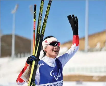  ?? ?? China’s Guo Yujie waves to spectators after winning the Beijing 2022 Winter Paralympic­s para biathlon women’s sprint standing event at the National Biathlon Centre in Zhangjiako­u, Hebei