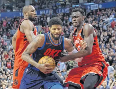  ?? CP PHOTO ?? Oklahoma City Thunder Paul George (centre) drives between Toronto Raptors Pascal Siakam (right) and Serge Ibaka during second half NBA basketball action in Toronto on Sunday.