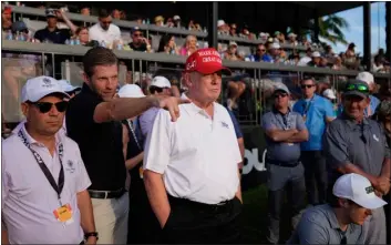  ?? AP PHOTO/REBECCA BLACKWELL ?? Republican presidenti­al candidate former President Donald Trump, center, and son Eric Trump, second left, watch play on the 18th hole green during the final round of LIV Golf Miami, at Trump National Doral Golf Club, Sunday, April 7, 2024, in Doral, Fla.