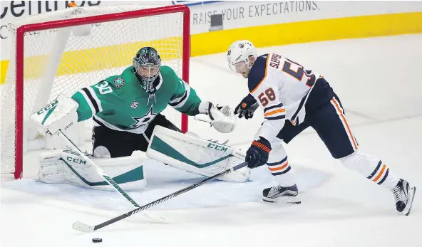  ?? — AP PHOTO ?? Stars goalie Ben Bishop poke checks Edmonton’s Anton Slepyshev in the second period of Saturday’s game in Dallas.