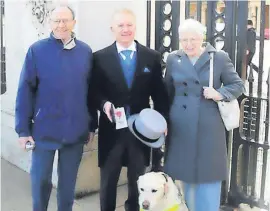  ?? ?? Proud Ike’s puppy raisers Jim and Anne Brown congratula­te Scott on his MBE