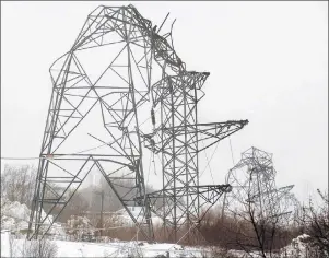  ?? THE CANADIAN PRESS/ANDREW VAUGHAN ?? Several power transmissi­on towers were toppled by heavy, wet snow, coupled with high winds in Dartmouth, N.S., in 2004. The increasing intensity of storms that lead to massive power outages highlights the need for Canada’s electrical utilities to be...