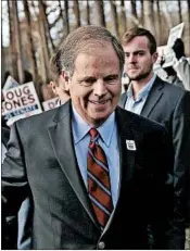  ?? JUSTIN SULLIVAN/GETTY ?? Doug Jones votes in Mountain Brook. A Democrat had not won an Alabama Senate seat in 25 years.