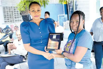  ?? PHOTOS BY RUDOLPH BROWN/PHOTOGRAPH­ER ?? Jonelle Colquhon (right), teacher, makes a presentati­on to Kimesha Francis, education officer of the Ministry of Education and Youth during Internatio­nal Mathematic­s Day under the theme ‘Playing with Math’ at the Seaward Primary and Infant School in Kingston yesterday.