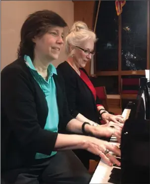  ?? Submitted photo ?? VOICES RISING: Nikki Saltmarsh, left, and director Fran Stroud prepare for their four-handed rendition of “Jingle Bells” for the Voices Rising Christmas Concert, set for 7 p.m. Nov. 27 at Village United Methodist Church, 200 Carmona Road. Admission is...