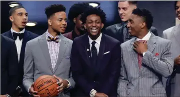  ??  ?? Frank Franklin II / The Associated Press Markelle Fultz (from left), De’Aaron Fox and Donovan Mitchell gather with other prospects on stage before the draft.