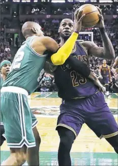  ?? Charles Kriupa/Associated Press ?? Cleveland’s LeBron James, right, is fouled by Boston’s Al Horford in the third quarter Wednesday night in Boston.