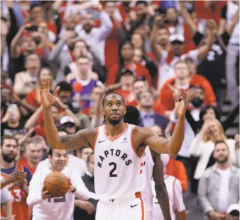  ?? Nathan Denette / Associated Press ?? Toronto’s Kawhi Leonard reacts after his team’s two-overtime win over Milwaukee. He scored eight of his 36 points in the second overtime and finished with nine rebounds and five assists.