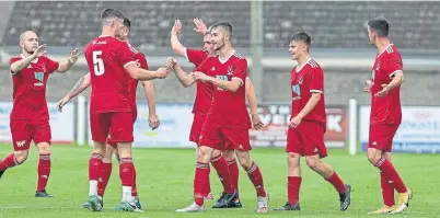  ??  ?? Deveronval­e players celebrate Robert Scott’s goal at Nairn