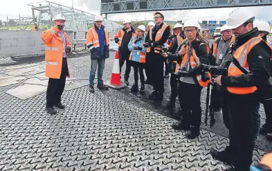  ?? Pictures: Getty. ?? Top: David Gough looks out from one lane of the Queensferr­y Crossing as final works are carried out; middle: cables stretch away to the south tower from the bridge deck; above: technical director Dr Mike Glover, left, gives a briefing on the...