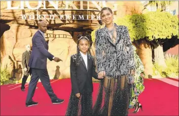  ?? Chris Pizzello Invision ?? BEYONCÉ and daughter Blue Ivy Carter arrive at the premiere of “The Lion King,” in which she voices Nala.