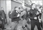  ?? AP/MAHMOUD ILLEAN ?? An Israeli police officer grabs a Palestinia­n protester Saturday in Jerusalem during a third day of demonstrat­ions.
