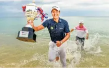  ?? Photo: Bangkok Post ?? Kaewkanjan­a celebrates with the trophy and his caddie Manop Santhia.