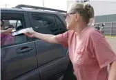  ?? ROGELIO V. SOLIS/AP ?? Longtime activist Barbara Beavers hands out anti-abortion materials Tuesday to an incoming patient outside the Jackson Women’s Health Organizati­on, Mississipp­i’s last remaining abortion clinic.