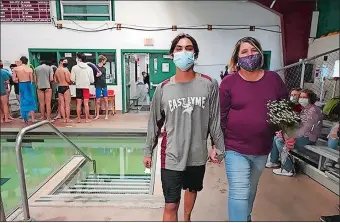  ?? PHOTO COURTESY OF EDITA KIRVELEVIC­IUS ?? East Lyme senior diver Ryan McLaughlin and his mom Laura take part in Senior Day activies on Feb. 15. McLaughlin is the favorite to win hits third straight Eastern Connecticu­t Conference championsh­ip today.