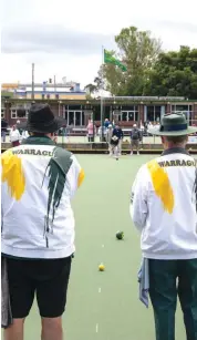  ??  ?? Above: David Smith (left) and Lester Mason look on as their team aims to land the ball right next to the jack once again during a social game on Melbourne Cup Day.