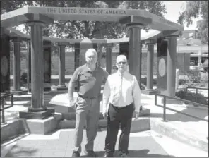  ??  ?? District Court Judge David Switzer, right, and Veterans Memorial of Garland County committee member Steve Smith oversee cleanup of the Veterans Memorial site in preparatio­n for the annual Memorial Day event. Community service workers, as part of the...