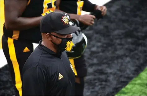  ?? (Pine Bluff Commercial/I.C. Murrell) ?? UAPB Coach Doc Gamble and players head into the locker room for halftime of their April 17 win over Prairie View A&M at Simmons Bank Field.