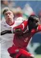  ?? DAVID ZALUBOWSKI/
THE ASSOCIATED PRESS ?? Canada’s Nikolas Ledgerwood, left, is hit by the ball as he pushes Panama’s Marcos Sanchez.