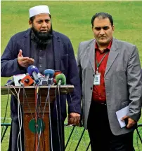  ?? — AFP ?? Chief selector Inzamam-ul-Haq along with PCB official Raza Kitchlew announces the squad for the West Indies tour.