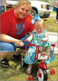  ?? Photo by Randy Moll ?? Hayden Hamm, 16 months, was a happy bike winner at Gentry’s Easter egg hunt in the city park on Saturday.