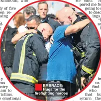  ??  ?? ®Ê EMBRACE: Hugs for the firefighti­ng heroes