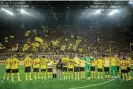  ?? Photograph: Sebastian Widmann/Bundesliga/Bundesliga Collection/Getty Images ?? Dortmund’s players thank supporters in the Yellow Wall after the 2-2 draw against Bayern Munich.