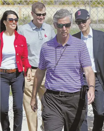  ?? STAFF PHOTO BY MATT STONE ?? TRAVEL GUIDE: Dave Dombrowski leads the way as he walks through camp with owner John Henry, president Sam Kennedy and Linda Pizzuti Henry.