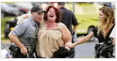  ?? STEVE APPS / WISCONSIN STATE JOURNAL ?? A women is escorted from the scene of a shooting Wednesday at a software company in Middleton, Wis., a suburb of Madison.