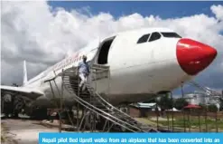  ??  ?? Nepali pilot Bed Upreti walks from an airplane that has been converted into an aviation museum in Kathmandu. — AFP photos