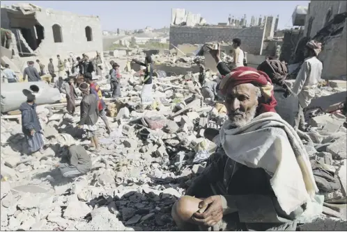  ?? Picture: Getty ?? A Yemeni man sits on the rubble as people search for survivors in houses destroyed by an overnight Saudi air strike in Sanaa