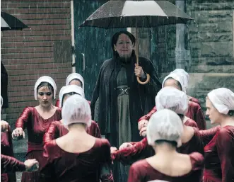  ?? PHOTOS: GEORGE KRAYCHYK/HULU ?? Ann Dowd as Aunt Lydia, centre, oversees handmaids in The Handmaid’s Tale. Margaret Atwood, who wrote the book on which the show is based, is collaborat­ing on the second season.