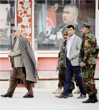  ?? Files/AFP ?? Afghan Vice President Abdul Rashid Dostum, left, walks at his headquarte­rs in Sheberghan on July 28, 2016.