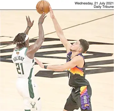  ?? RONALD MARTINEZ/AGENCE FRANCE-PRESSE ?? JRUE Holiday of the Milwaukee Bucks (left) and Devin Booker of the Phoenix Suns will play together for Team USA in the Tokyo Olympics.