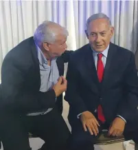  ?? (Courtesy Peleg) ?? LIKUD’S TOP candidate for the Jerusalem City Council, Elisha Peleg, chats up Prime Minister Benjamin Netanyahu at a party event yesterday in Ramat Gan.