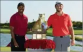  ?? AP PHOTO/DANTE CARRER ?? Jon Rahm, right, poses with Tiger Woods after Rahm won the Hero World Challenge at Albany Golf Club in Nassau, Bahamas, on Sunday.
