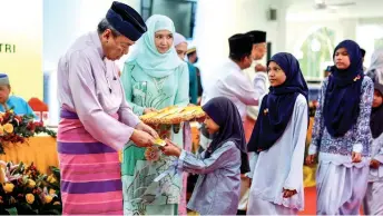  ?? — Bernama photo ?? Orphans queue to receive ‘duit raya’ from Sultan Sharafuddi­n.